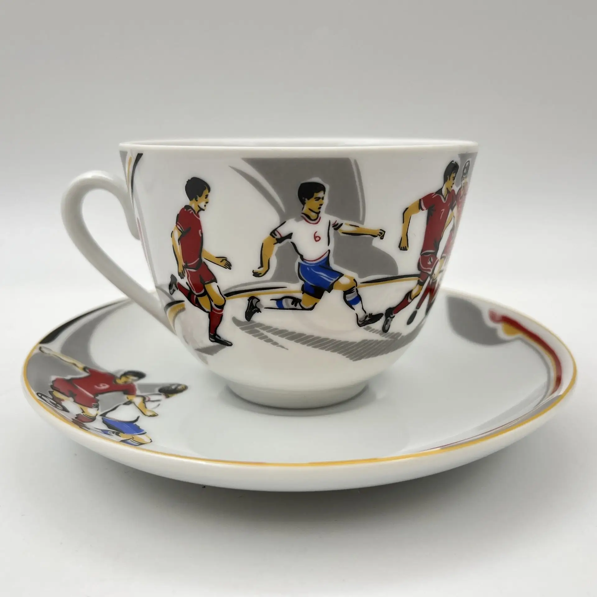 Cup and saucer with a football motif
